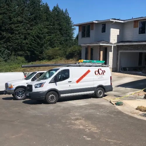 Clark County Plumbing service vehicles parked in front a two-story home in Riveridge