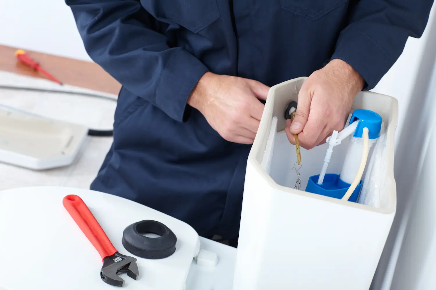 plumber repairing a toilet