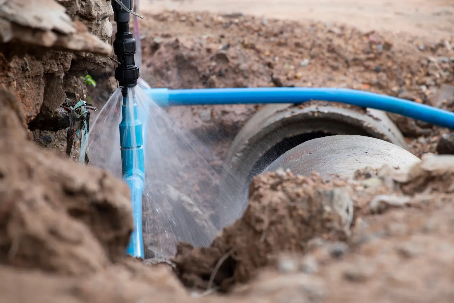 exposed, broken water line spraying water